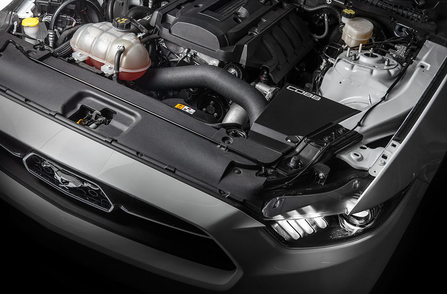 Cobb Tuning cold air intake installed in an EcoBoost Mustang engine bay, showcasing the intake system and engine components.