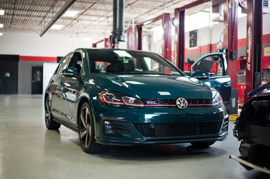 Great Falls Green MK7.5 GTi parked in a garage with its door open, ready for an APR Stage 1 Tune.